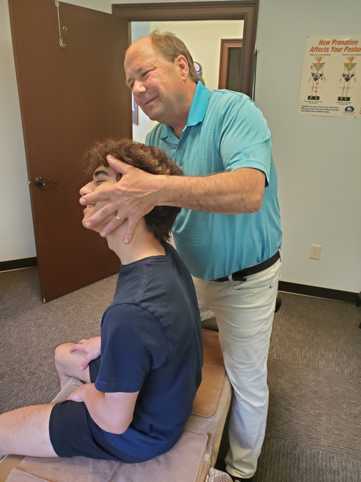 chiropractic patient receiving a neck and spine adjustment from Frank Stizmann 